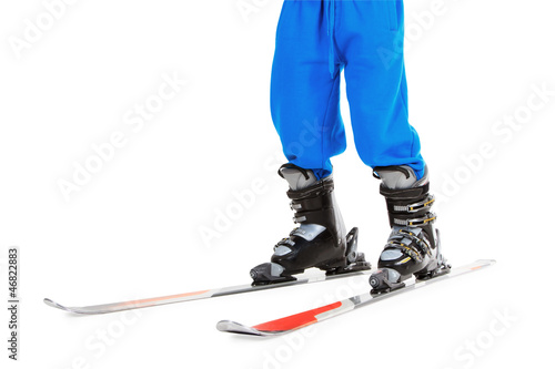 woman's legs in ski boots, standing on skis