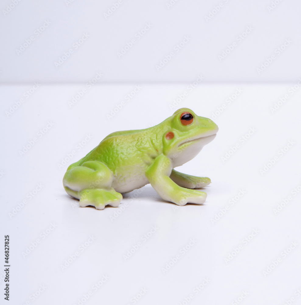 side view of plastic frog, white background side view of plastic frog, white background
