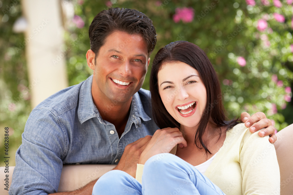 Couple Relaxing On Sofa At Home Couple Relaxing On Sofa At Home
