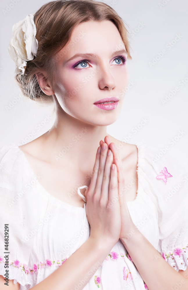 Fototapeta premium Devotion. Faith. Young christian woman praying against her sin