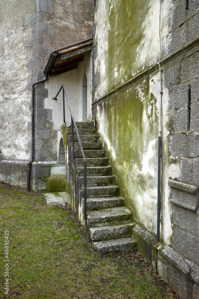 Stone staircase on green wall