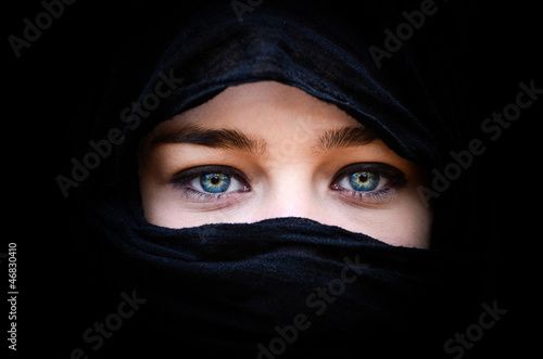 Portrait of beautiful woman with blue eyes wearing black scarf