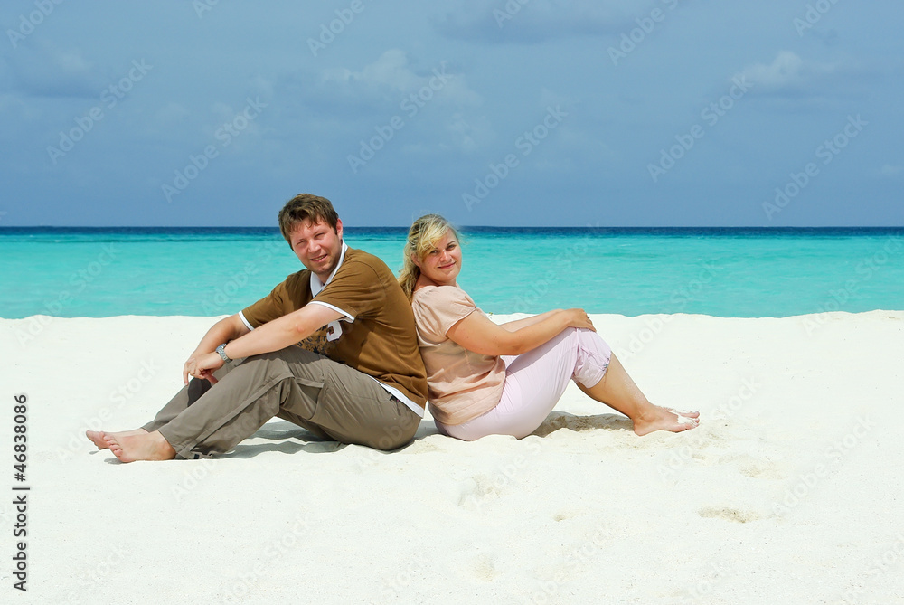 Young couple on caribbean beach on honeymoon