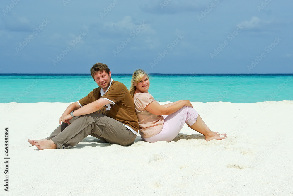 Young couple on caribbean beach on honeymoon Young couple on caribbean beach on honeymoon