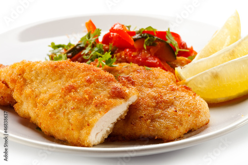 Fried chicken fillets and vegetables