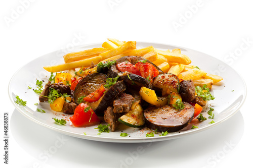 Roasted meat, French fries and vegetables