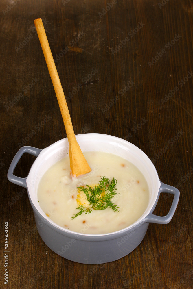 Mashed potatoes in saucepan on wooden table Mashed potatoes in saucepan on wooden table