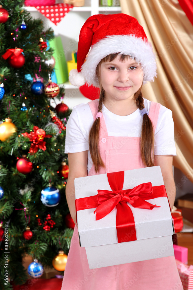 Little girl with Christmas toys in festively decorated room Little girl with Christmas toys in festively decorated room