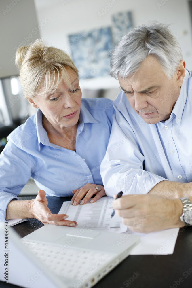 Senior couple inquiring bank website for help Senior couple inquiring bank website for help