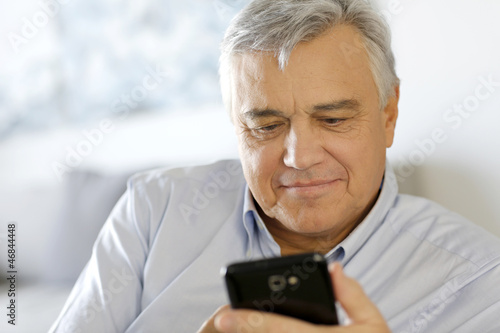 Portrait of senior man using smartphone © goodluz