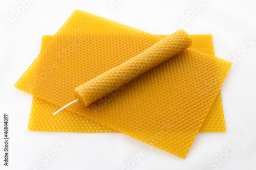 Candle made of beeswax on honeycomb - background