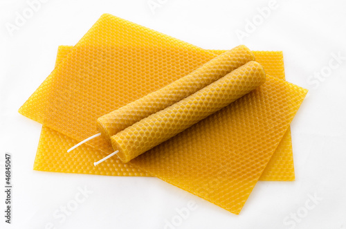 two Candle made of beeswax on honeycomb - background