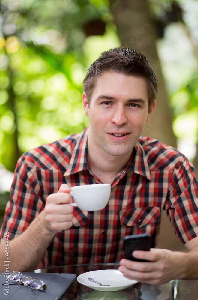 Business man sitting at table in cafe using mobile phone Business man sitting at table in cafe using mobile phone