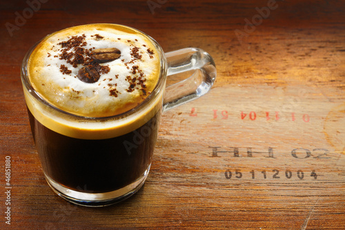 Frothy cup of cappuccino coffee photo