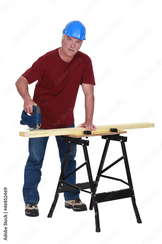 Carpenter cutting piece of wood to size Carpenter cutting piece of wood to size