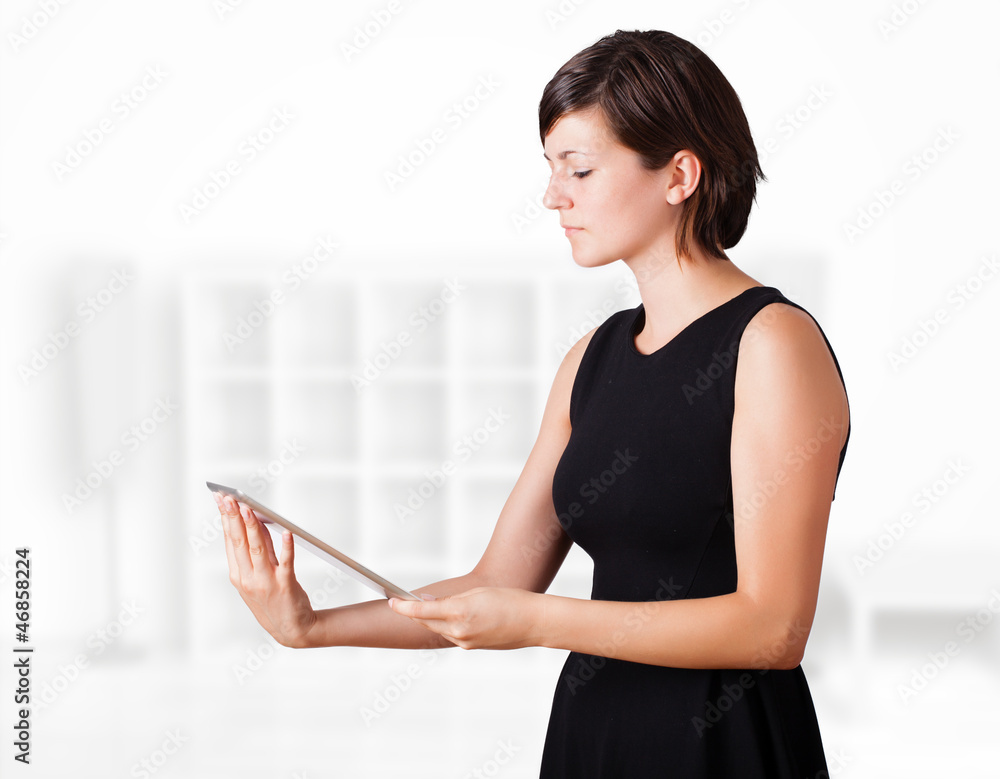 Young woman looking at modern tablet