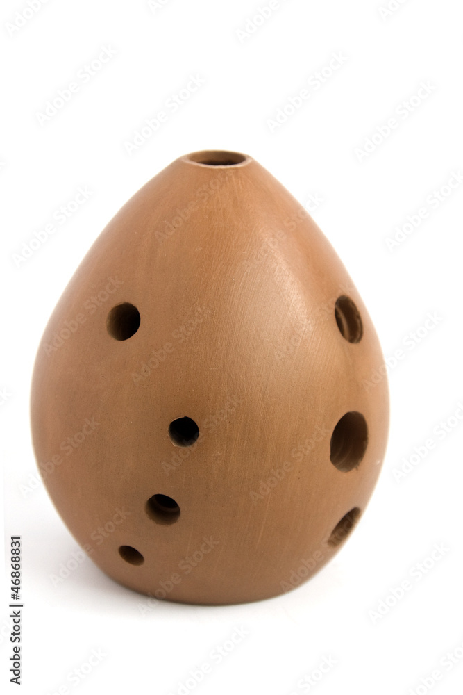 Foto de Ancient Asian musical instrument ocarina isolated do Stock
