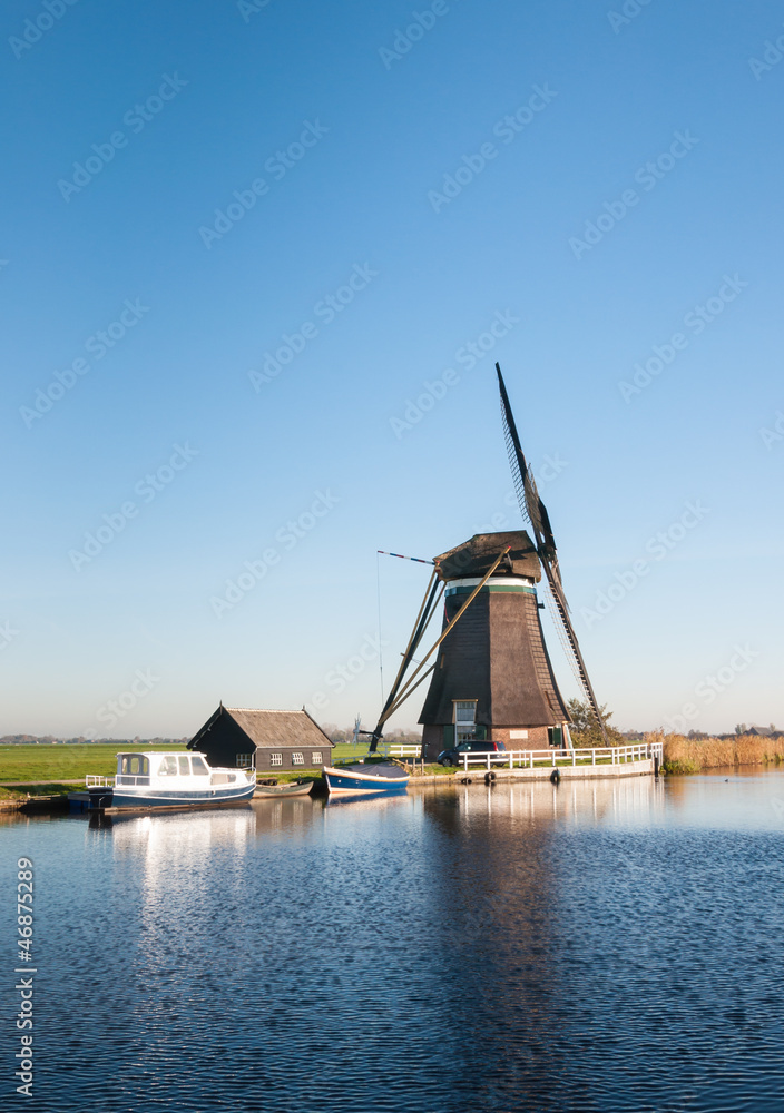 Dutch windmill on the river banks Dutch windmill on the river banks