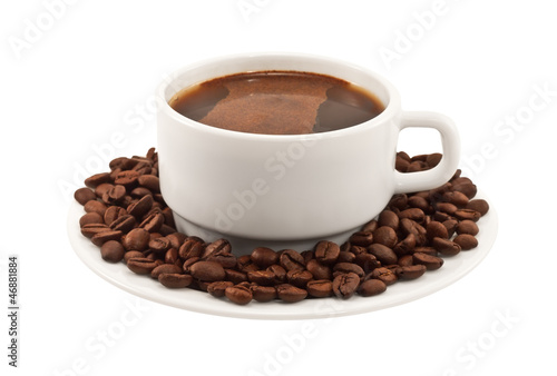 White cup of coffee with beans on a plate
