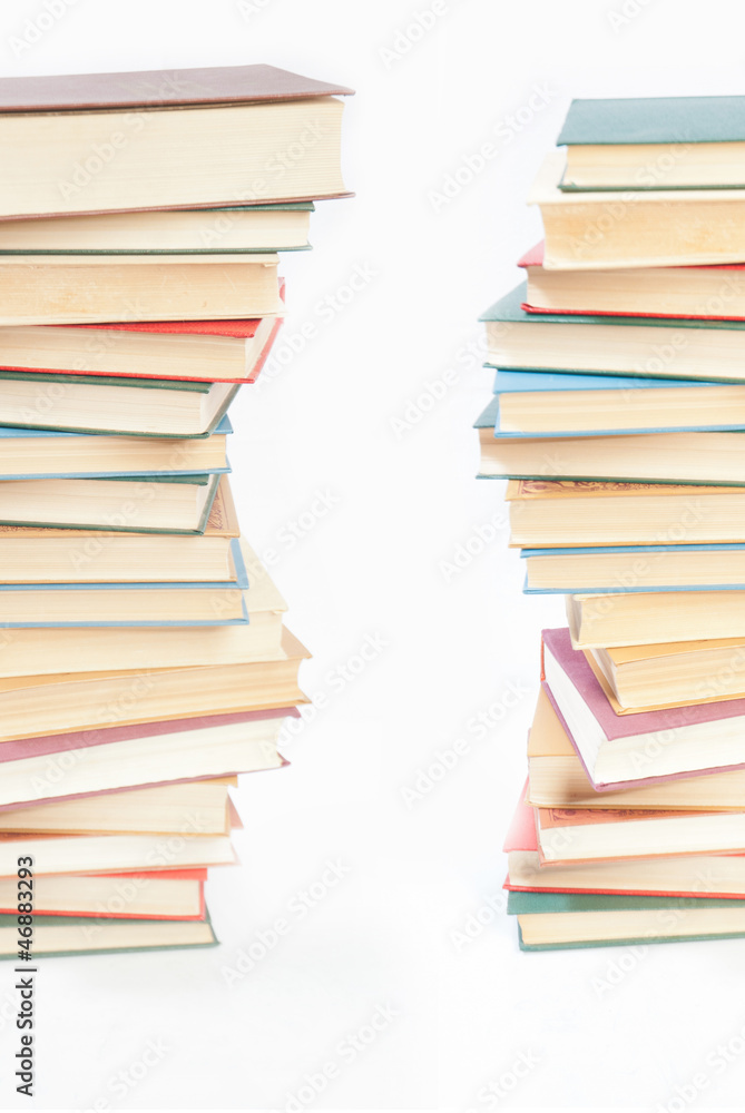 Two towers of books on white Two towers of books on white