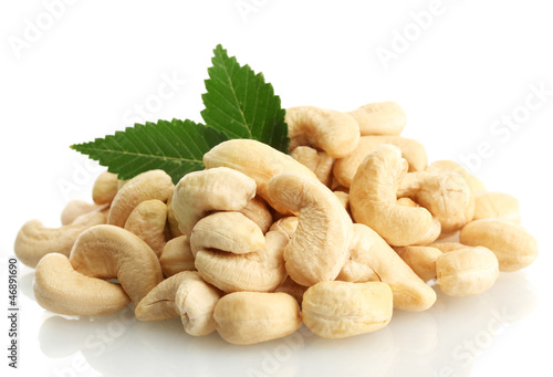 tasty cashew nuts with leaves, isolated on white photo