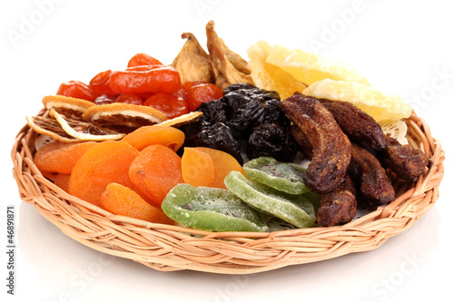 Dried fruits on wicker plate isolated on white