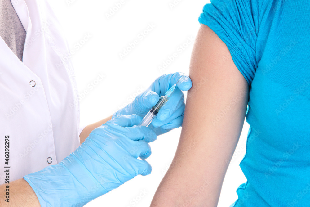 doctor holding syringe with vaccine into patient's shoulder doctor holding syringe with vaccine into patient's shoulder