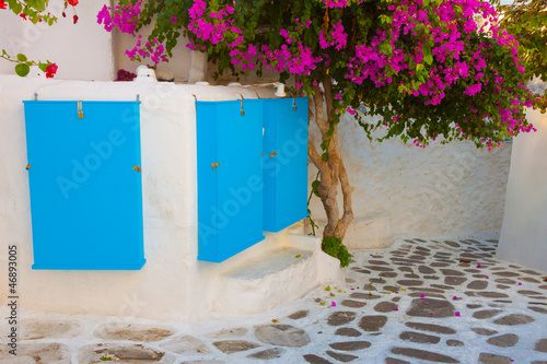 Traditional colorful view in narrow alley in Mykonos island cycl photo