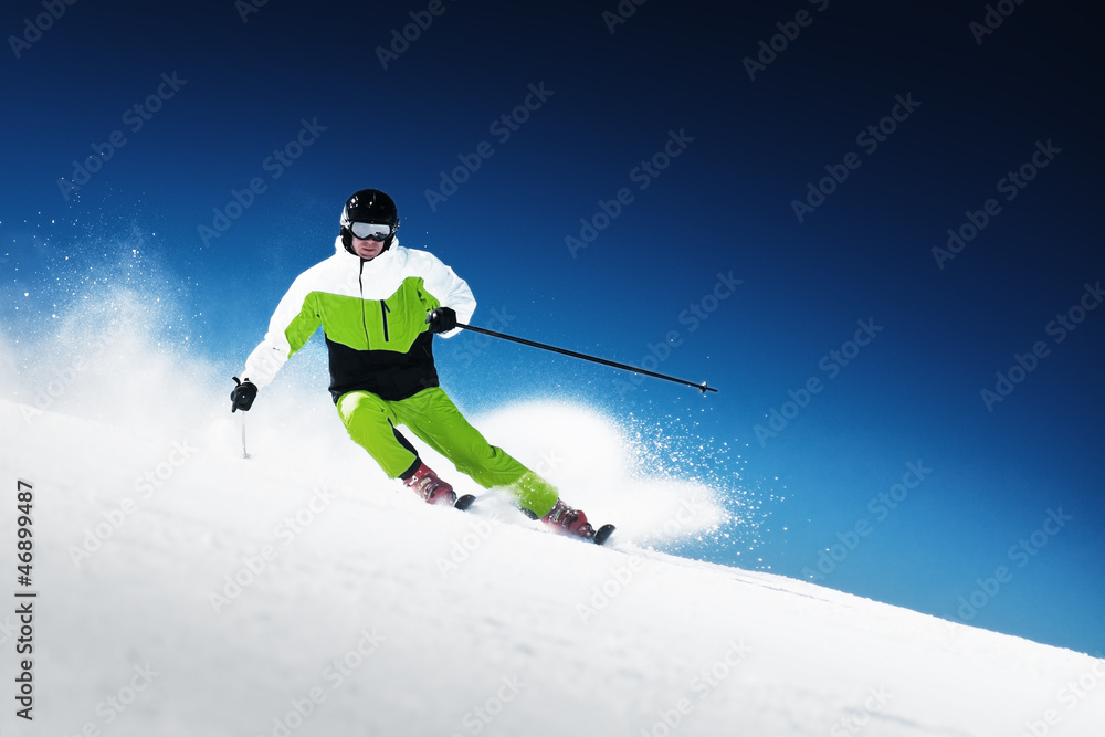 Skier in mountains, prepared piste and sunny day Skier in mountains, prepared piste and sunny day