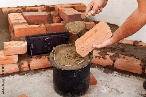 Starting to build a stove - closeup on hands