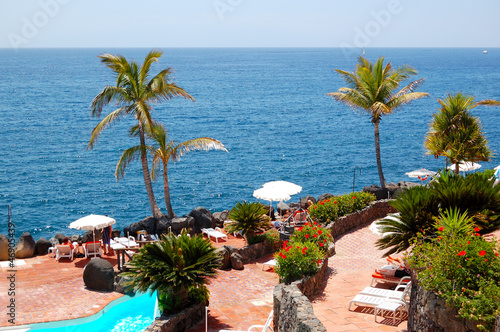 View on the beach, palms and swimming pool of luxury hotel, Tene © slava296