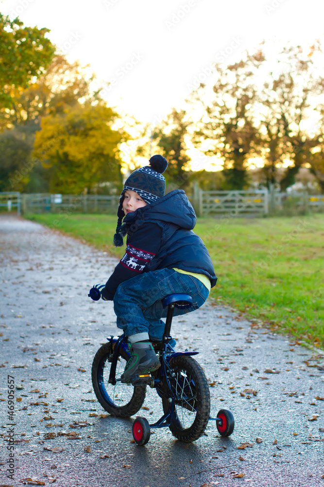 boy riding his bike through a countryside path