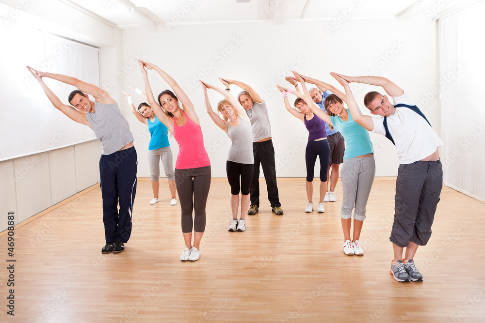 Pilates class exercising in a gym