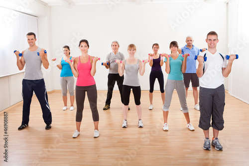 Aerobics class working out with dumbbells