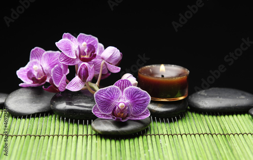 Branch orchid with candle and orchid with black stone