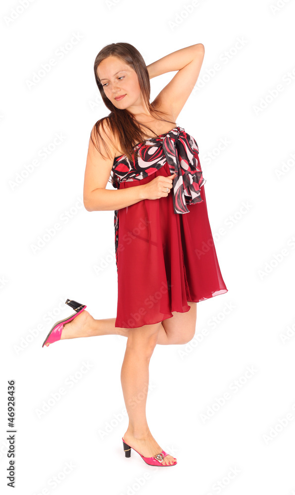 Beautiful dreaming woman dressed in red pareo poses in studio