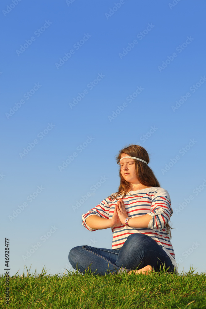 Fat girl meditates and thinks at green grass Fat girl meditates and thinks at green grass