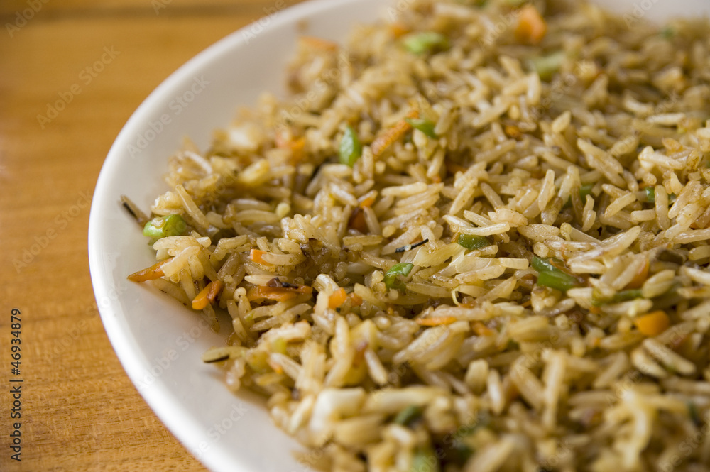 Indian cuisine: plate of vegetable fried rice (shallow DOF)