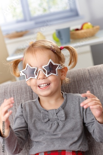 Little girl in star shaped glasses smiling