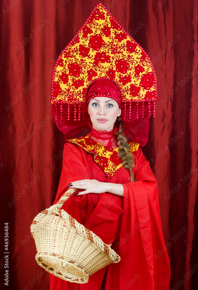 Woman in russian traditional clothes with basket