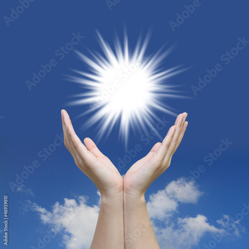 Beautiful hand sun and blue sky with solar power concept photo