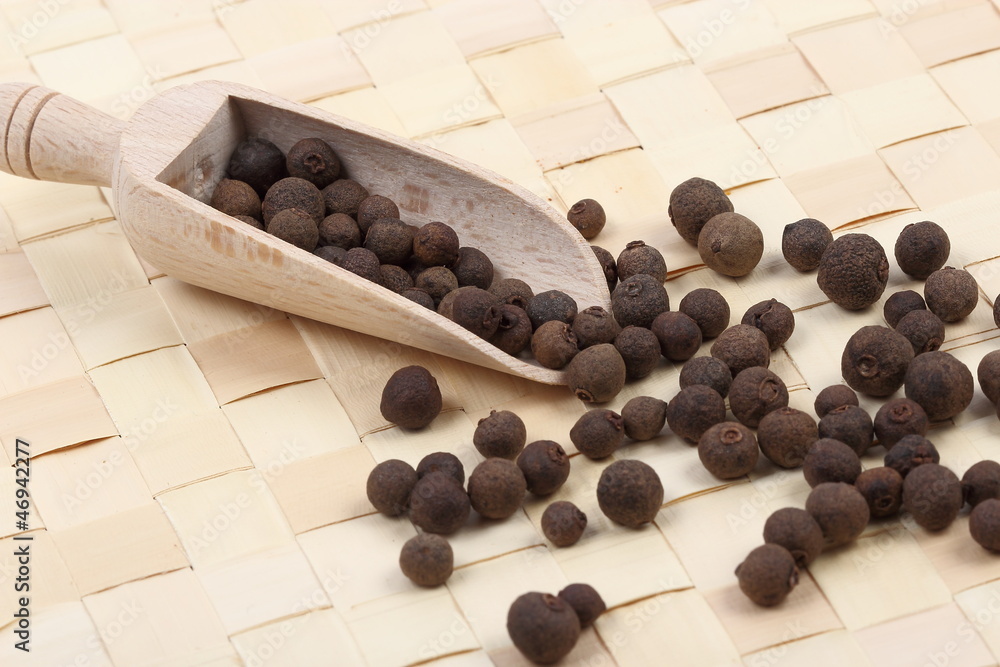Allspice berries on a table mat Allspice berries on a table mat