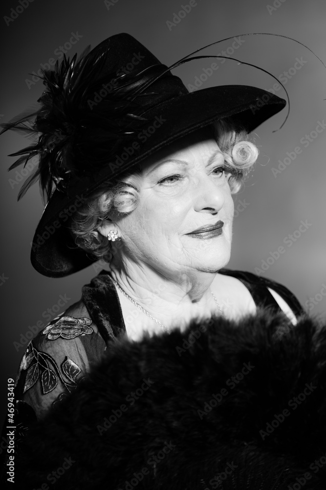 Obraz premium Senior woman glamour vintage style. Black and white studio shot.