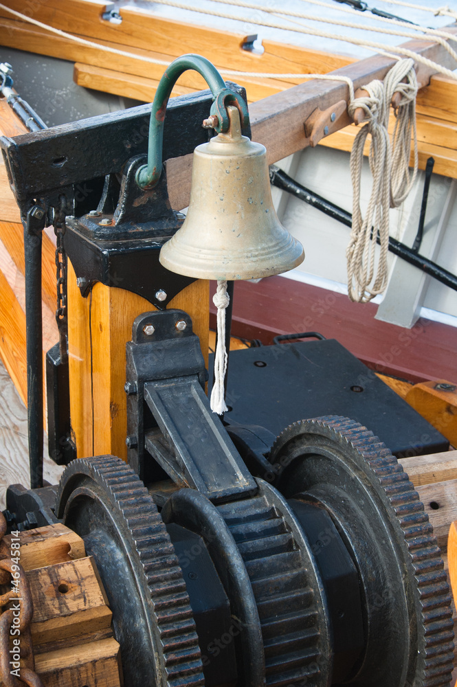 ship's Bell and anchor lifting mechanism on an old sailboat