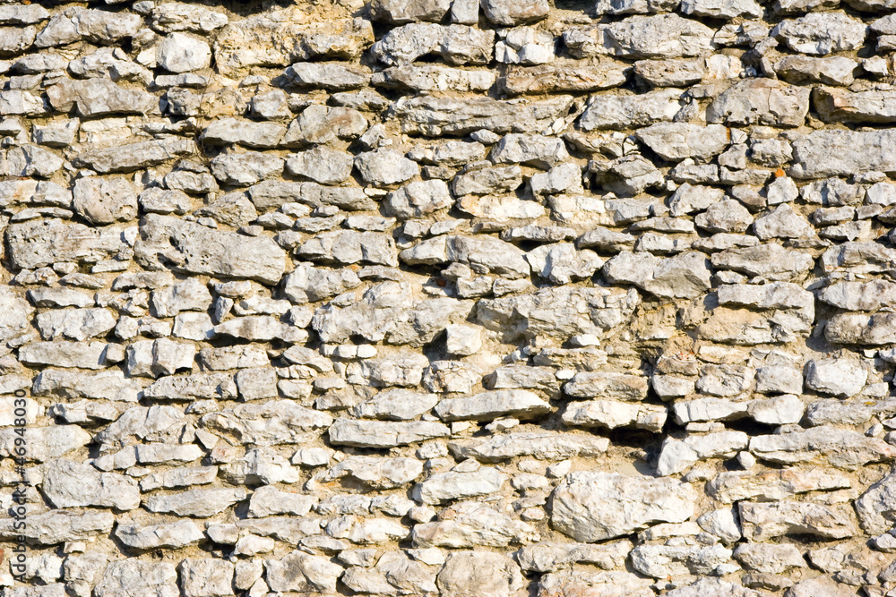 Old weathered stone wall for background