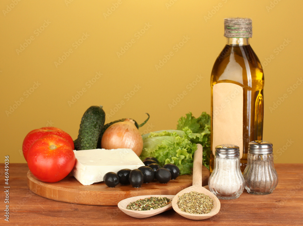 Ingredients for a Greek salad on brown background close-up Ingredients for a Greek salad on brown background close-up