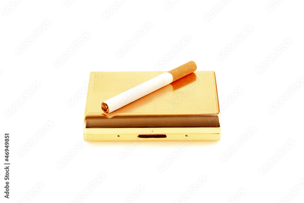gold cigarette-case with a cigarette on a white background gold cigarette-case with a cigarette on a white background