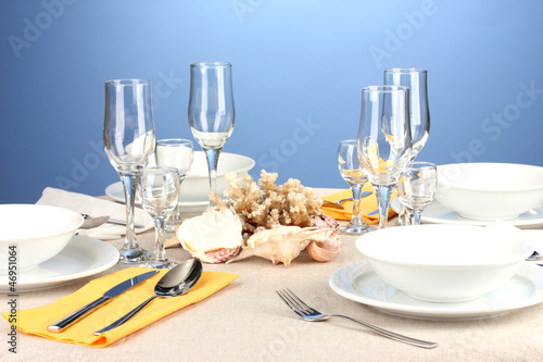 Table setting in white and yellow tones on color  background © Africa Studio