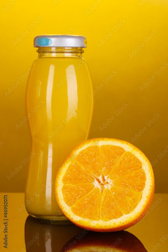 Delicious orange juice in a bottle and orange next to it Delicious orange juice in a bottle and orange next to it