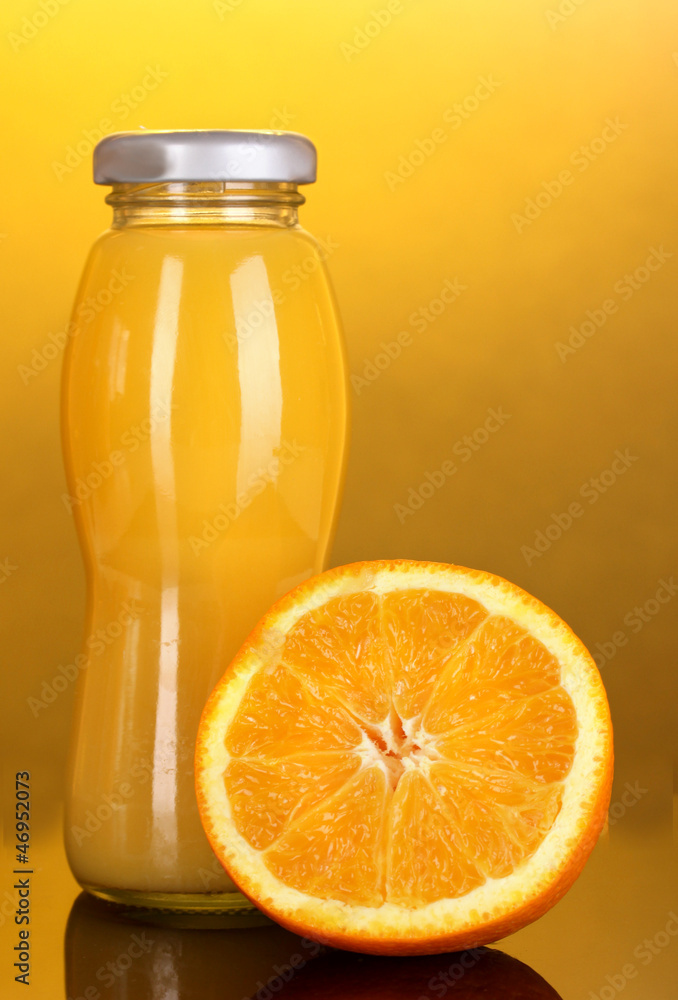 Delicious orange juice in a bottle and orange next to it Delicious orange juice in a bottle and orange next to it